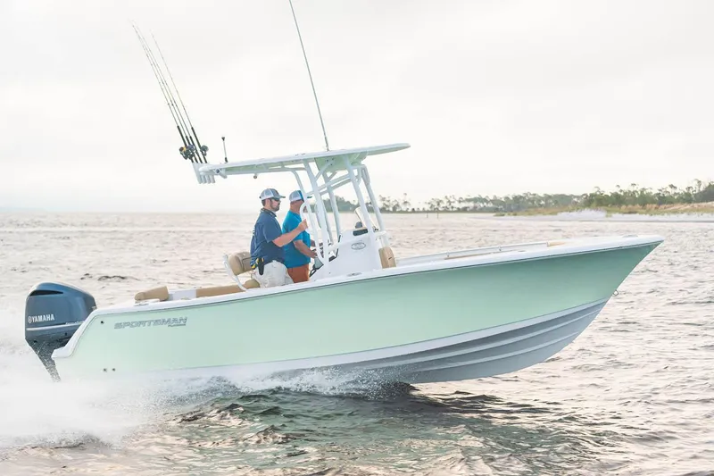 Slide: The Image of 2023 Sportsman Open 232 Center Console boat on trailer, side view in sunlight. - 2