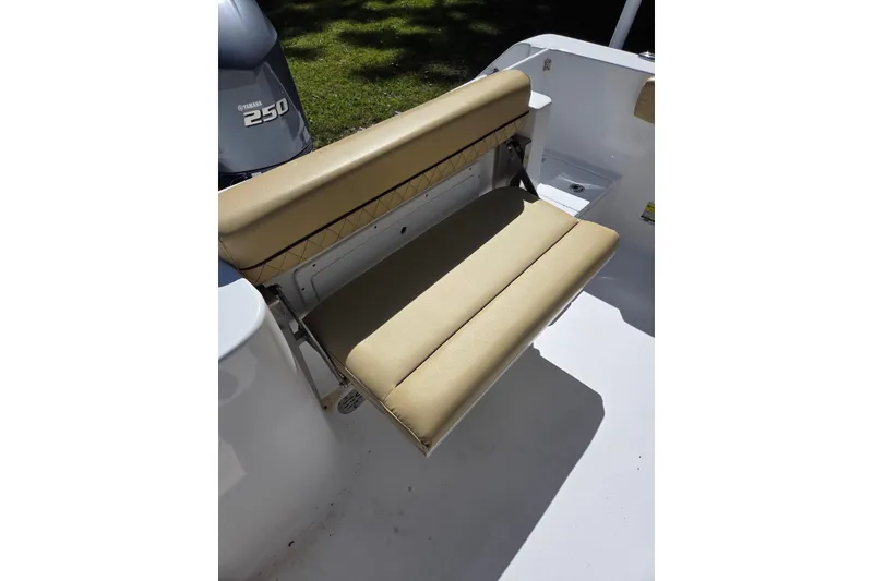 Slide: The Image of 2023 Sportsman Open 232 Center Console boat with beige seating and Yamaha 250 engine. - 24