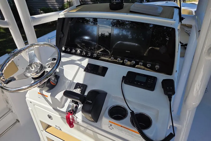 Slide: The Image of 2023 Sportsman Open 232 Center Console dashboard with steering wheel and navigation controls. - 25