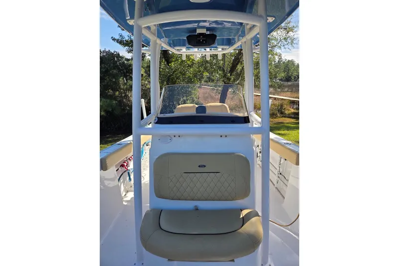Slide: The Image of 2023 Sportsman Open 232 Center Console boat interior with seating and console view. - 28