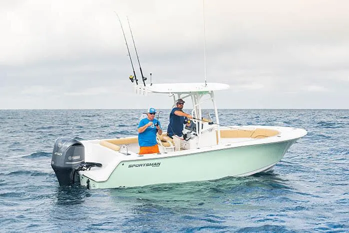 Slide: The Image of 2023 Sportsman Open 232 Center Console boat on trailer, blue hull, outdoor setting. - 3