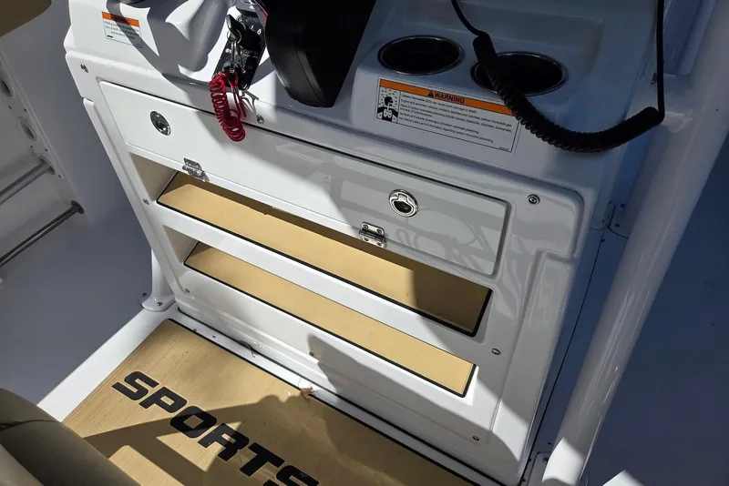 Slide: The Image of 2023 Sportsman Open 232 Center Console interior with storage compartments and cup holders. - 31