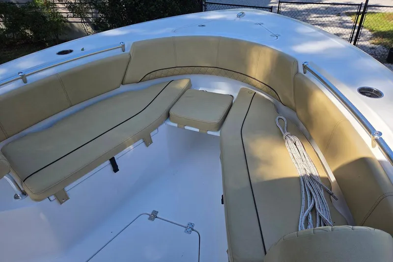 Slide: The Image of 2023 Sportsman Open 232 Center Console boat with beige seating and rope on deck. - 37