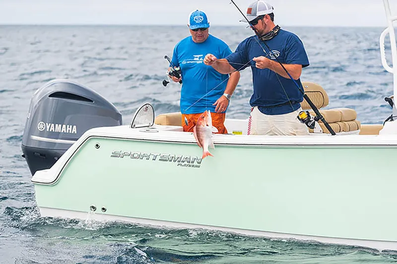 Slide: The Image of 2023 Sportsman Open 232 Center Console boat docked on a serene lake. - 4