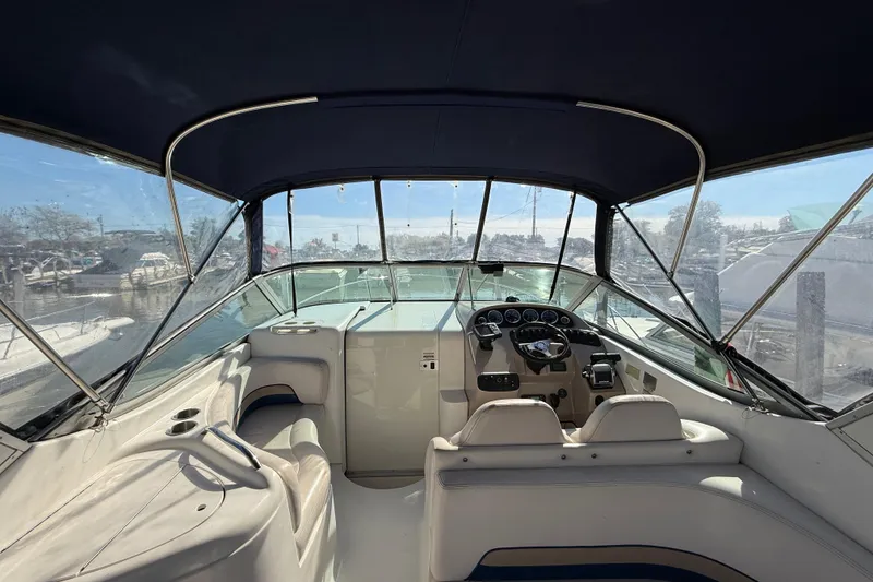 Slide: The Image of 1999 Chaparral Signature 300 boat interior with steering wheel and seating area. - 10