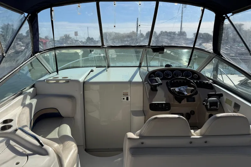 Slide: The Image of 1999 Chaparral Signature 300 boat cockpit with steering wheel and dashboard controls. - 11