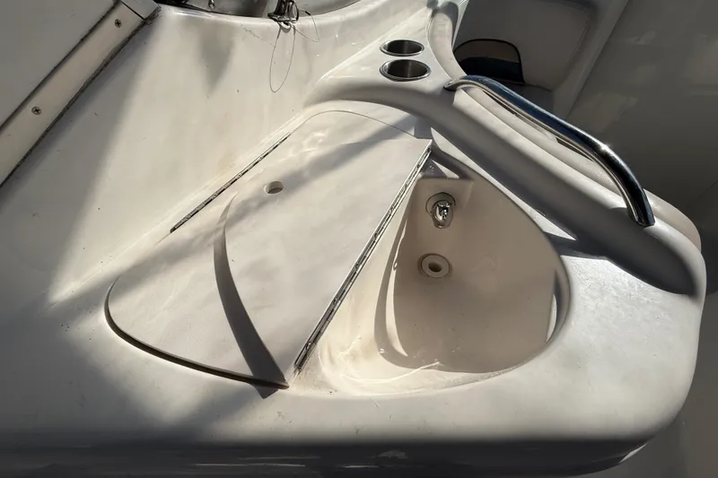 Slide: The Image of 1999 Chaparral Signature 300 boat interior with sink and cup holders. - 12
