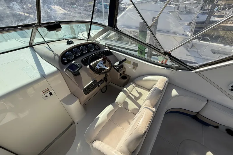 Slide: The Image of 1999 Chaparral Signature 300 boat cockpit with steering wheel and control panel. - 13