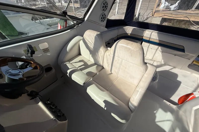 Slide: The Image of 1999 Chaparral Signature 300 boat interior with steering wheel and seating area. - 14