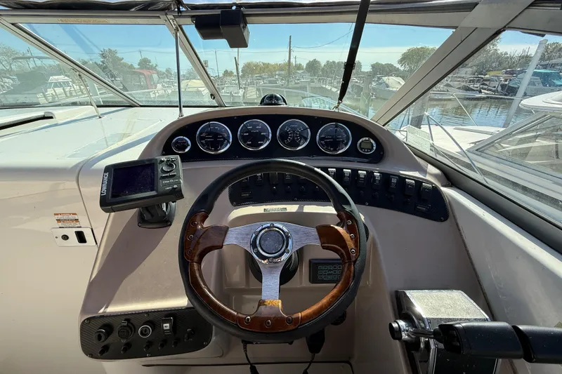 Slide: The Image of 1999 Chaparral Signature 300 boat dashboard with steering wheel and gauges. - 15