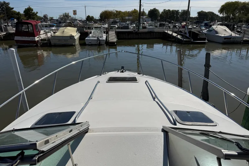 Slide: The Image of 1999 Chaparral Signature 300 boat docked in a marina, surrounded by other boats. - 20