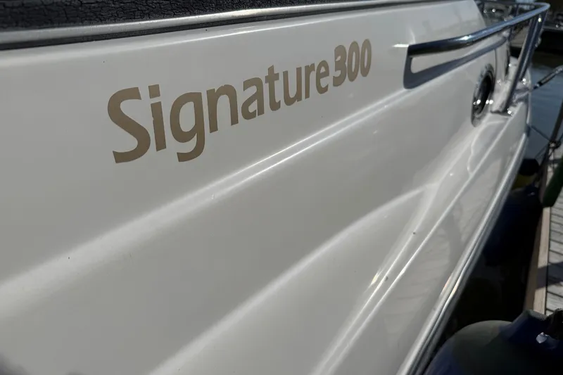 Slide: The Image of 1999 Chaparral Signature 300 boat side view with logo and railing. - 3