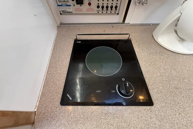 Slide: The Image of 1999 Chaparral Signature 300 boat kitchen with electric stove and control panel. - 36