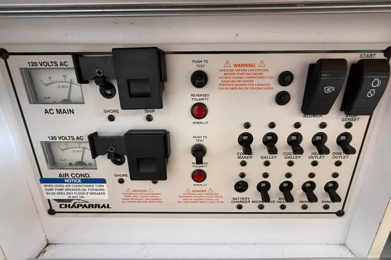 Slide: The Image of Control panel of a 1999 Chaparral Signature 300 boat with various switches and warnings. - 37