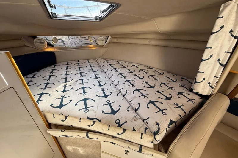 Slide: The Image of 1999 Chaparral Signature 300 cabin interior with anchor-patterned bedding. - 40