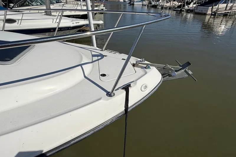 Slide: The Image of 1999 Chaparral Signature 300 boat docked at marina, showing bow and anchor. - 5