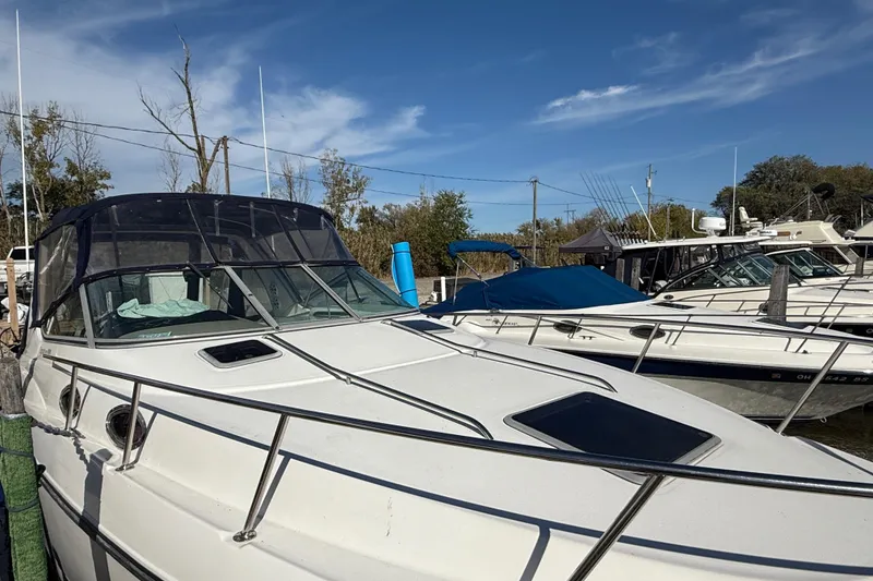 Slide: The Image of 1999 Chaparral Signature 300 boat docked under clear blue sky. - 6
