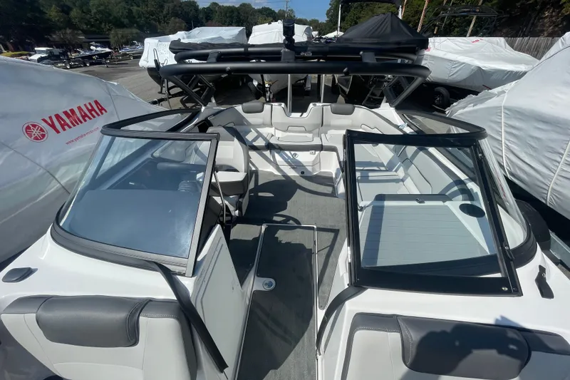 Slide: The Image of 2026 Yamaha Boats AR190 interior with open seating and windshield, displayed outdoors. - 12