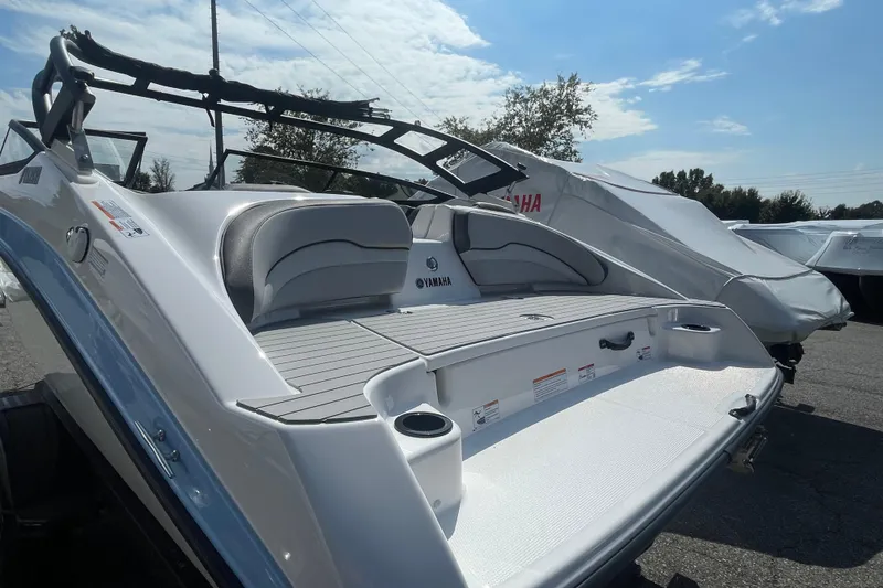 Slide: The Image of 2026 Yamaha Boats AR190, sleek design, spacious seating, outdoor display under blue sky. - 16