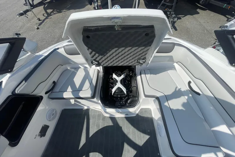 Slide: The Image of 2026 Yamaha Boats AR190 engine compartment with open hatch, showcasing interior seating and design. - 17