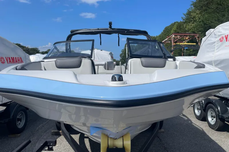 Slide: The Image of 2026 Yamaha Boats AR190, sleek design, parked outdoors, clear sky background. - 2