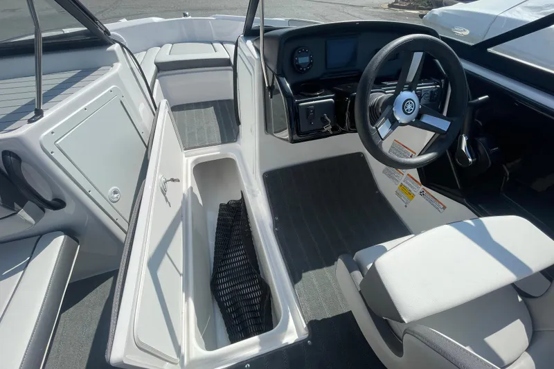 Slide: The Image of 2026 Yamaha AR190 boat interior with open storage compartment and steering wheel. - 7