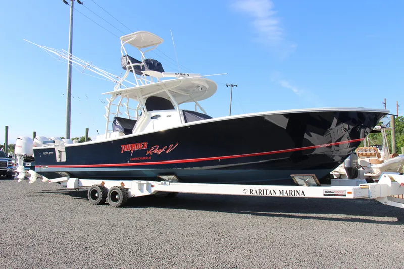 The Image of 2016 Regulator 41 boat on trailer at Raritan Marina, clear sky background. - 0