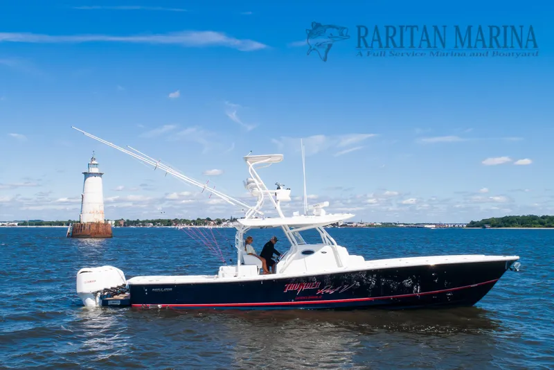 Slide: The Image of 2016 Regulator 41 boat cruising near a lighthouse on a sunny day. - 4