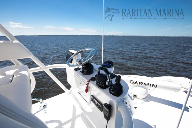 Slide: The Image of 2016 Regulator 41 boat helm with Garmin equipment, overlooking calm waters. - 6