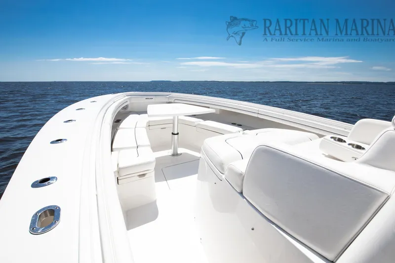 Slide: The Image of 2016 Regulator 41 boat with white seating, table, and ocean view. - 7