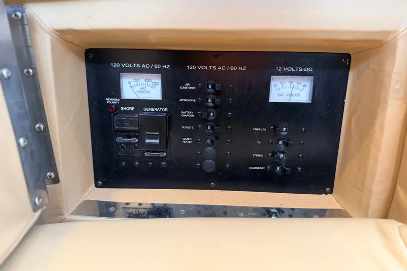 Slide: The Image of Electrical control panel in a 2020 Cobalt R35 boat, featuring AC and DC voltage meters. - 11