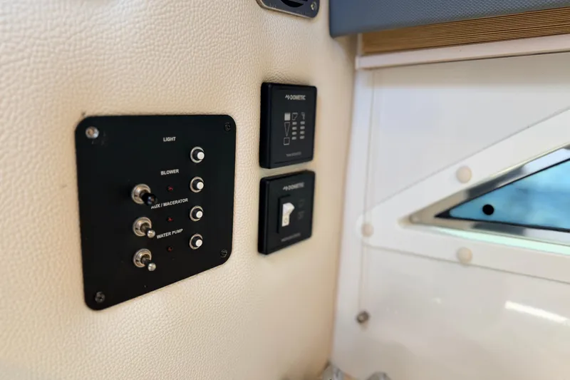 Slide: The Image of Control panel inside 2020 Cobalt R35 boat, featuring switches and buttons. - 15