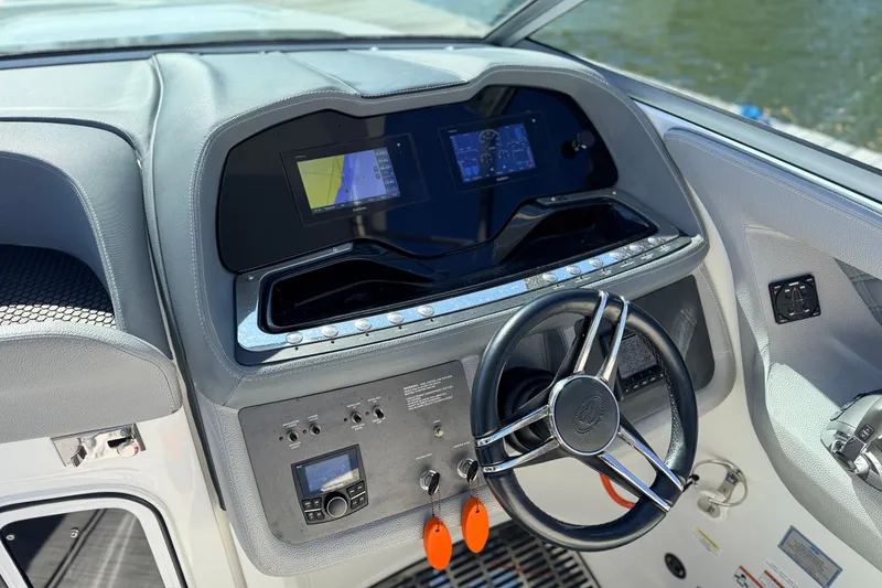 Slide: The Image of Cockpit of 2020 Cobalt R35 boat with modern steering and navigation displays. - 17