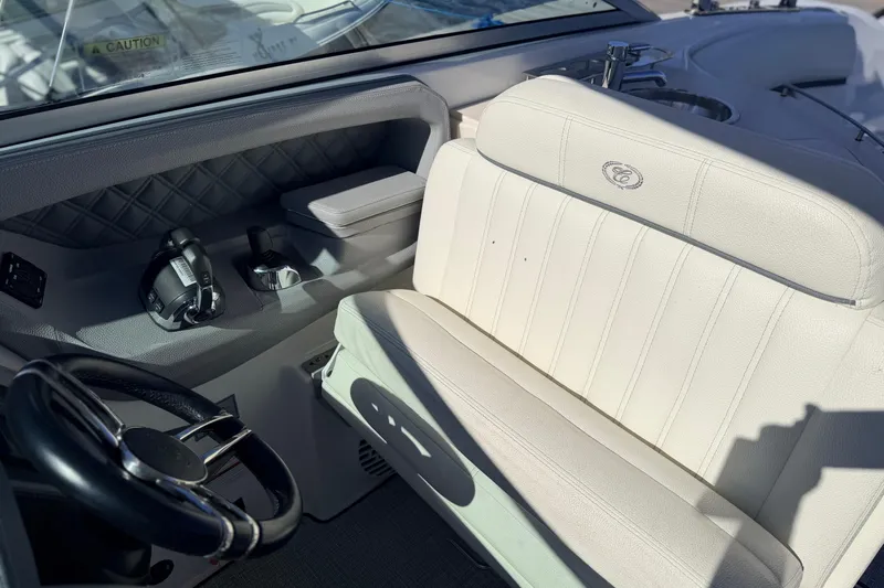 Slide: The Image of 2020 Cobalt R35 boat interior with white leather seating and steering wheel. - 18
