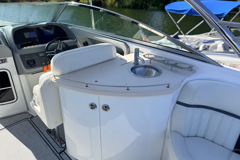 Slide: The Image of 2020 Cobalt R35 boat interior with helm, sink, and seating area. - 19