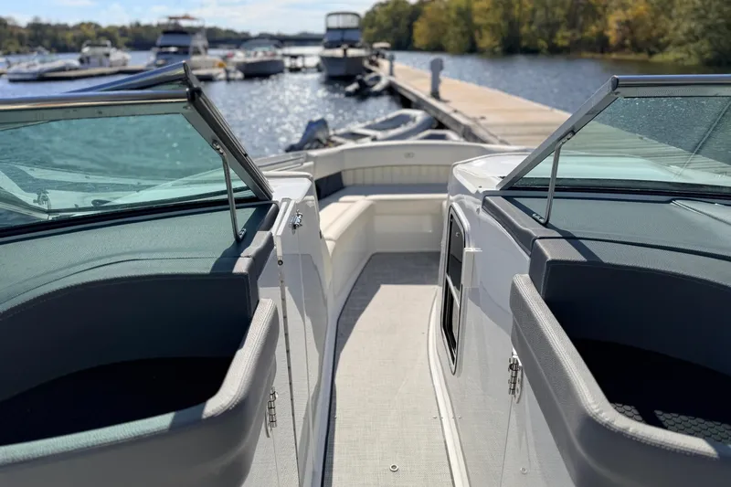 Slide: The Image of 2020 Cobalt R35 boat docked at marina, featuring open deck and windshield. - 26