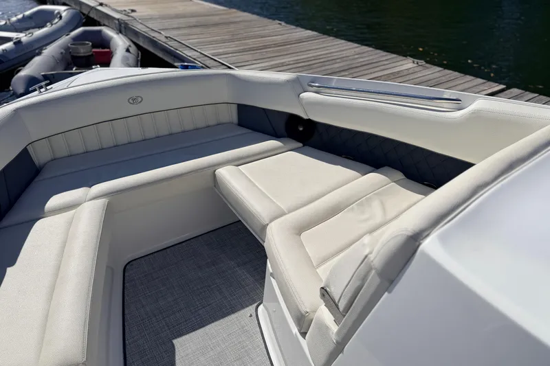 Slide: The Image of Interior of a 2020 Cobalt R35 boat with white seating and dockside view. - 27