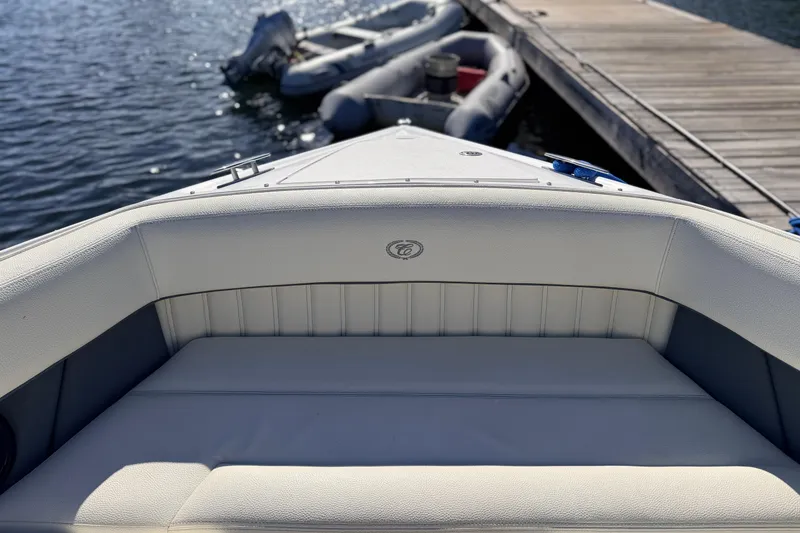 Slide: The Image of Front view of a 2020 Cobalt R35 boat docked by the water. - 28
