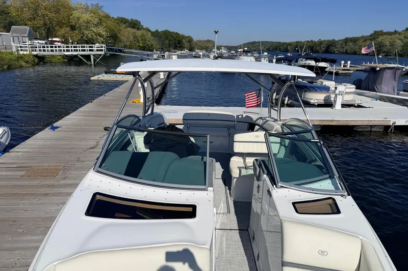 Slide: The Image of 2020 Cobalt R35 boat docked at a marina with American flag. - 31