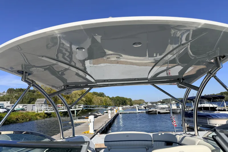 Slide: The Image of 2020 Cobalt R35 boat docked at marina under clear blue sky. - 32