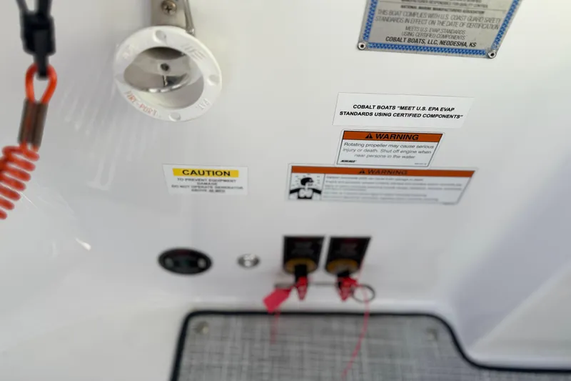Slide: The Image of Control panel of 2020 Cobalt R35 boat with safety warnings and labels. - 34