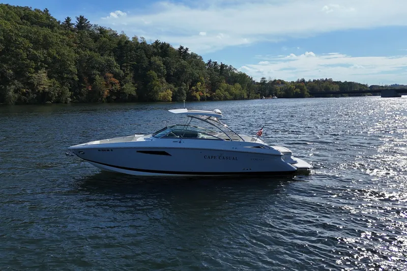 Slide: The Image of 2020 Cobalt R35 boat on a scenic lake with forested shoreline. - 7
