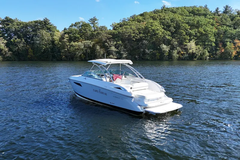 Slide: The Image of 2020 Cobalt R35 boat on a serene lake with lush green trees. - 8