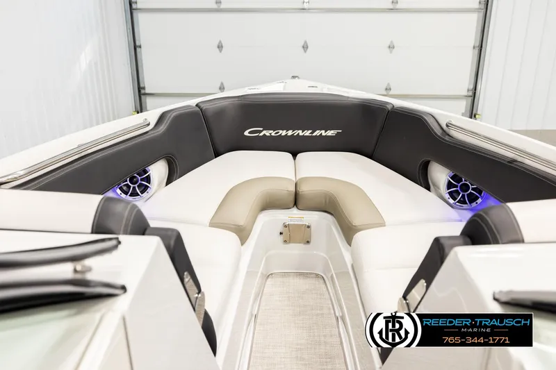 Slide: The Image of 2022 Crownline 265 SS boat interior with cushioned seating and speakers. - 16