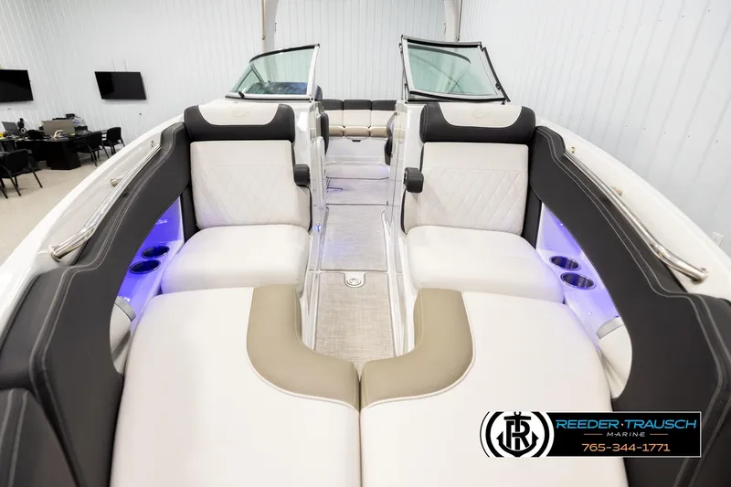 Slide: The Image of 2022 Crownline 265 SS boat interior with luxurious seating and ambient lighting. - 18