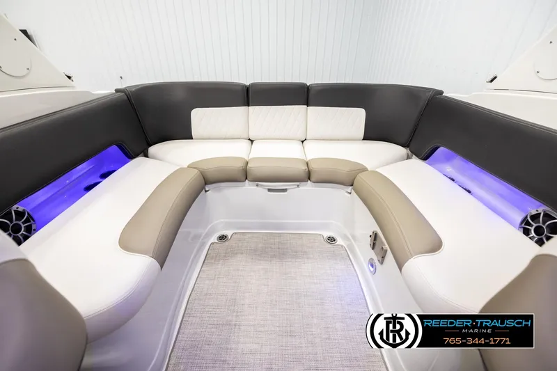 Slide: The Image of 2022 Crownline 265 SS boat interior with plush seating and ambient lighting. - 20