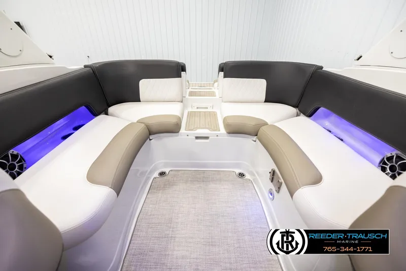 Slide: The Image of 2022 Crownline 265 SS boat interior with plush seating and ambient lighting. - 21