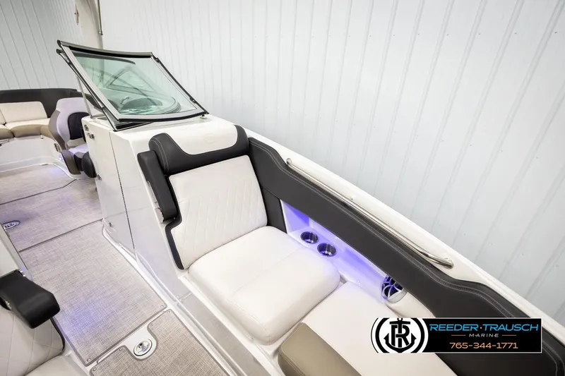 Slide: The Image of 2022 Crownline 265 SS boat interior with white seating and modern design. - 23