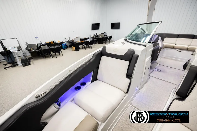 Slide: The Image of 2022 Crownline 265 SS boat interior with luxurious seating in a showroom. - 25