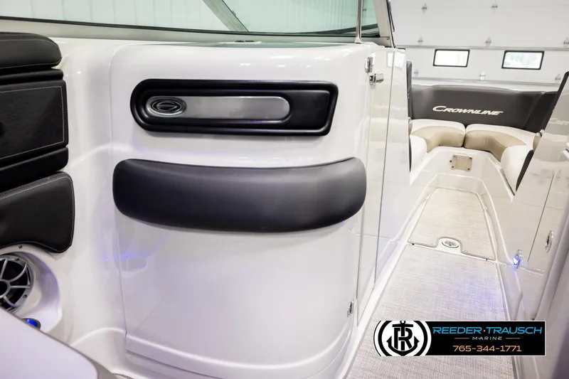 Slide: The Image of 2022 Crownline 265 SS boat interior with seating and logo, Reeder-Trausch Marine branding. - 27
